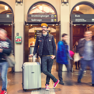 kille med resväska på en station